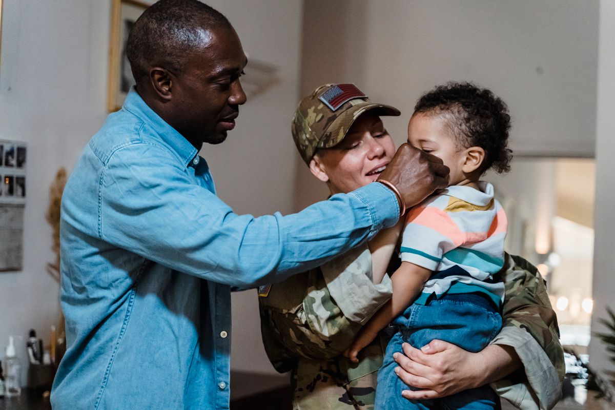 A family embracing a loved one returning home